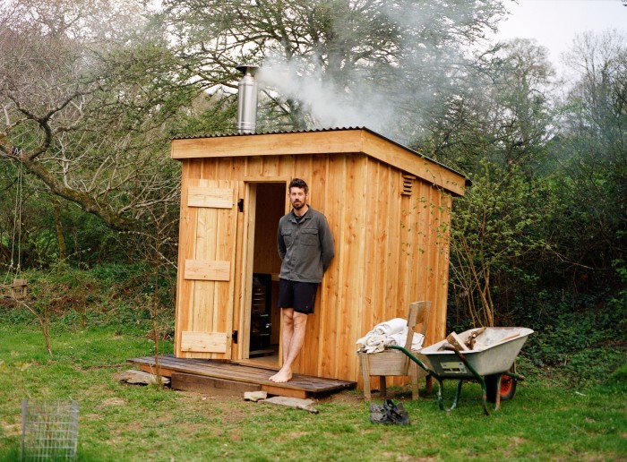 Joseph Turnbull and the sauna he built outside the barn he converted in Cornwall