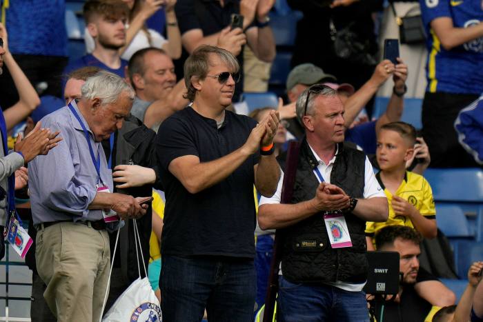 American businessman Todd Boehly, centre, applauds as he attends the English Premier League soccer match between Chelsea and Watford at Stamford Bridge