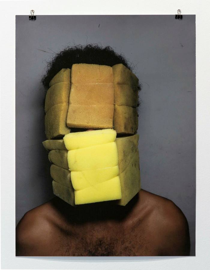 Photo of a man with sponges covering his face
