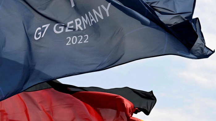 A German national flag and a flag for the G7 summit fly in Garmisch-Partenkirchen, southern Germany