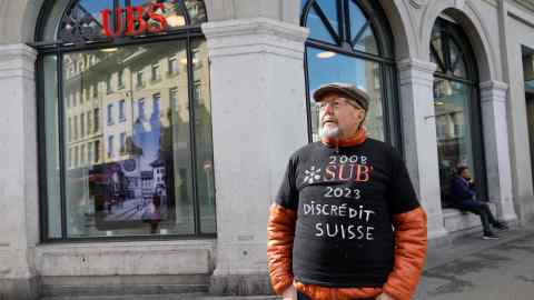 A demonstrator outside a UBS branch in the Swiss capital Bern on Monday