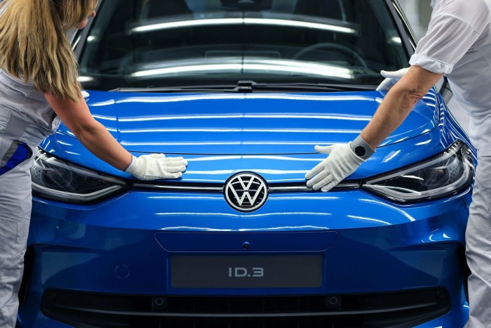 Employees make final checks on a Volkswagen