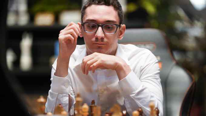 Chess grandmaster Fabiano Caruana contemplates his next move on the board