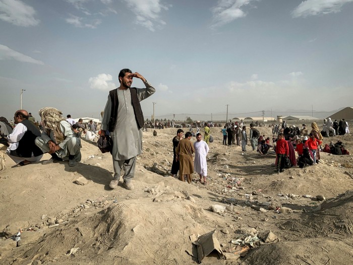 People gather near the north gate of the airport in Kabul, August 21