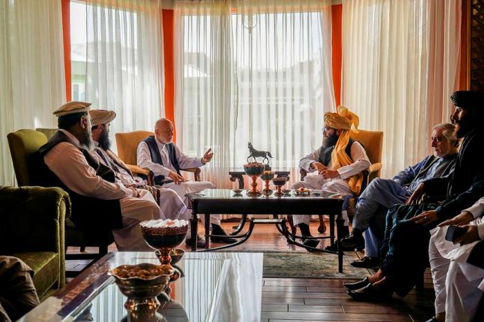Former Afghan president Hamid Karzai and senior Haqqani group leader Anas Haqqani during a meeting in Kabul on August 18