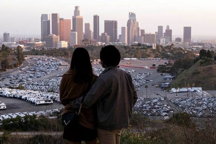 People watch the sunset from Elysian Park in Los Angeles amid the coronavirus pandemic, which has brought large parts of the global economy to a standstill