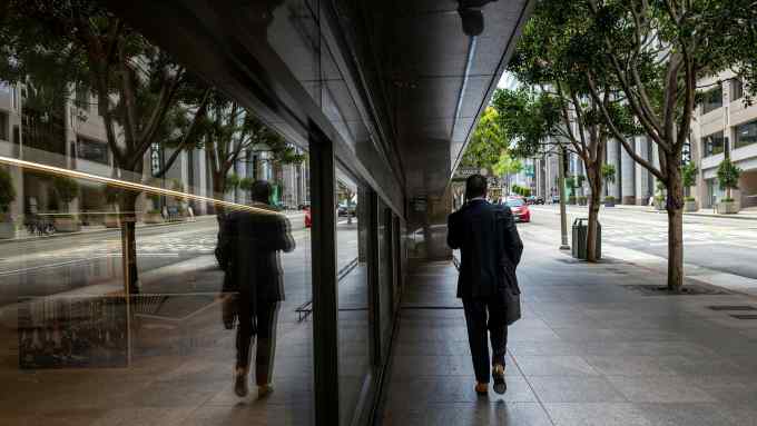 A pedestrian on California Street in the financial district of San Francisco, California