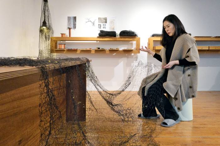 Kyeok Kim inspecting Second Surface at her showroom and studio