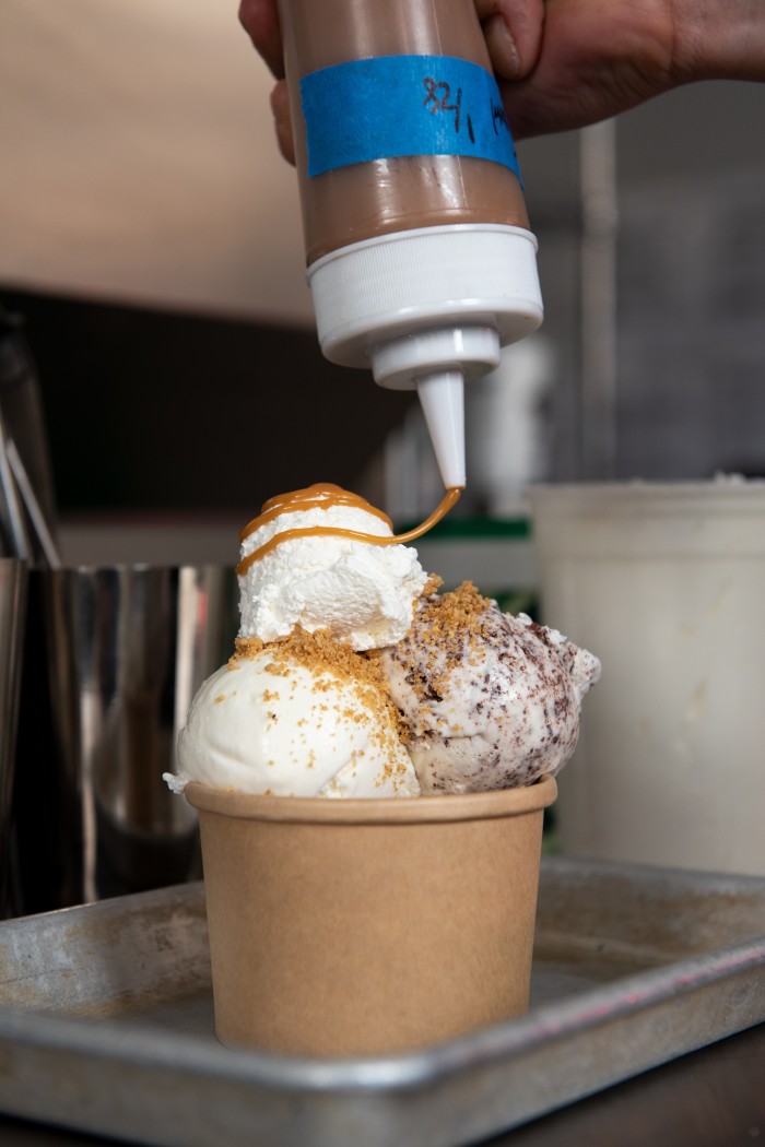 A tub of ice cream at Caffè Panna is finished with a drizzle of sauce