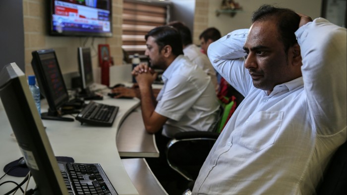Indian stock traders react at a local brokerage company in Mumba