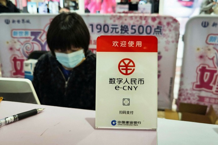 A sign for China’s new digital currency, electronic Chinese yuan (e-CNY), is displayed at a shopping mall in Shanghai