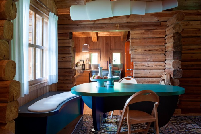 chalet interior with wood panelling and contemporary table