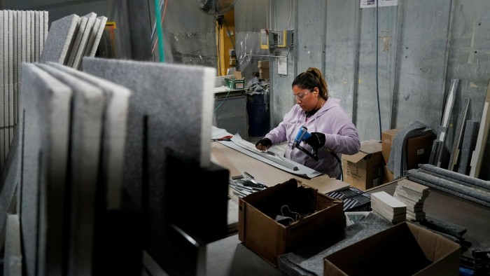 A worker assembles the interior of a safe that is being manufactured at Liberty Safe Company in Payson, Utah, US