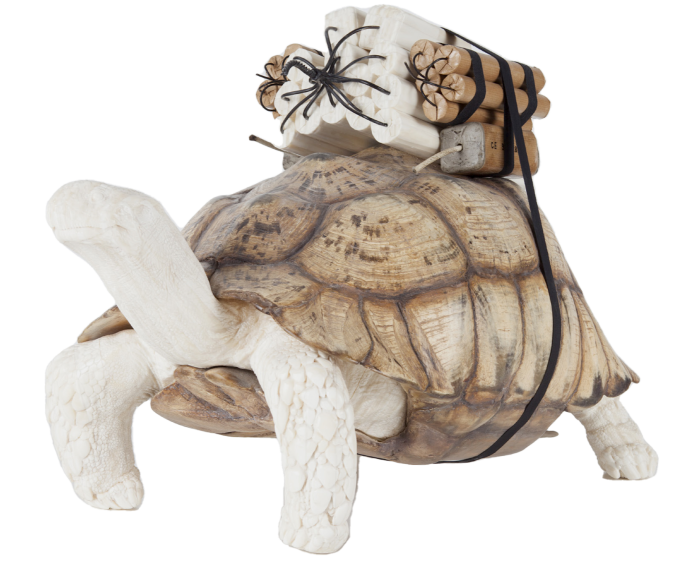 A white clay tortoise with dynamite strapped to its shell