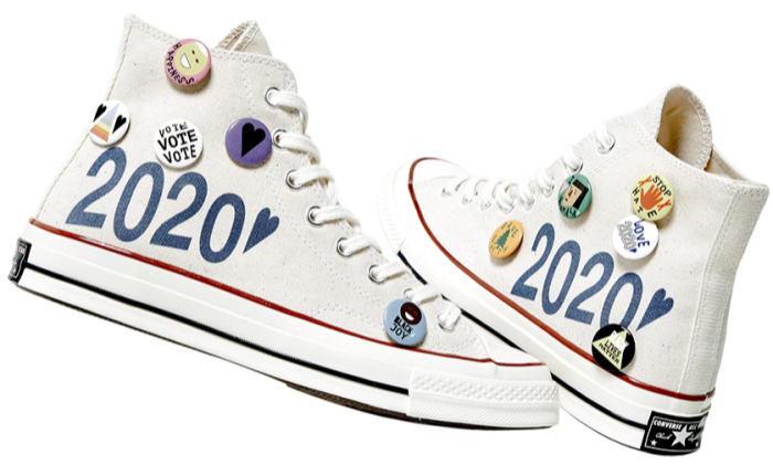 White canvas shoes with 2020 in blue writing and pro-voting badges on the sides