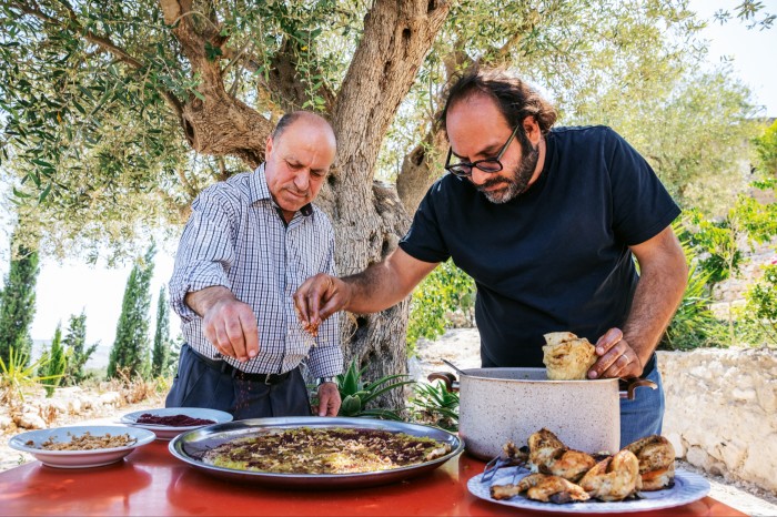 Kattan (right) makes musakhan with restaurateur Abu Mohammad