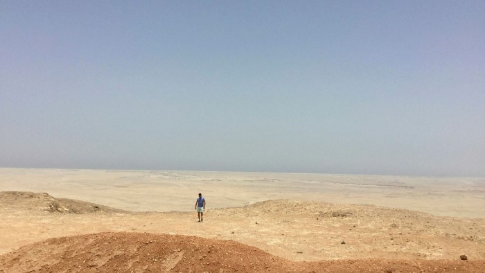 man walking in a desert