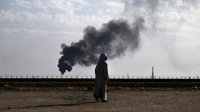 Smoke billows from gas flaring in the Rumaila oil field in Iraq’s southern province of Basra