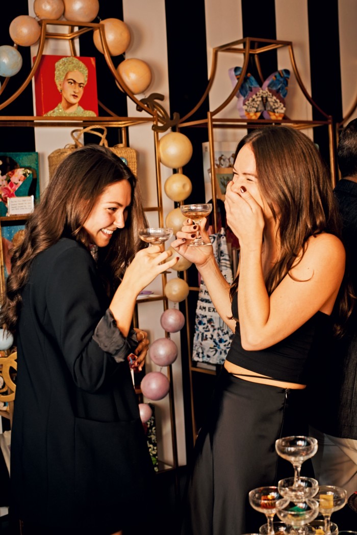 Ashley Longshore team members Emilie Eliopoulos and Nora Kaboulov share a toast