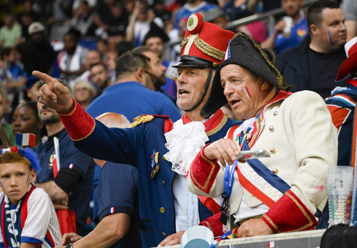 A men dressed as Napoleon, and another in a soldier’s uniform with tall hat and white frilled shirt