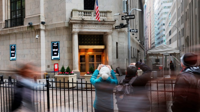 People taking pictures of the New York Stock Exchange