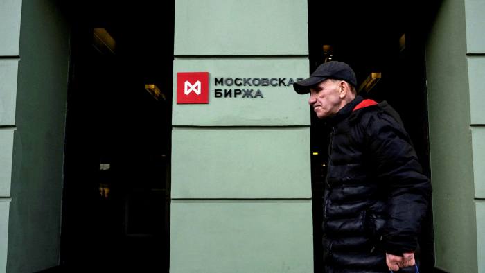 A man walks past the Moscow stock market building in Moscow on February 28, 2022
