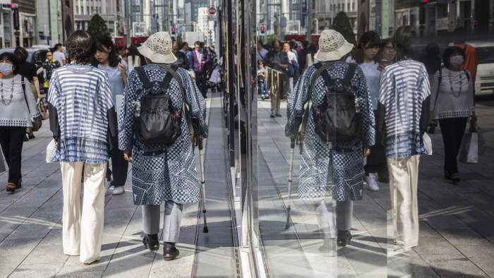 Pedestrians walk along a street in Tokyo