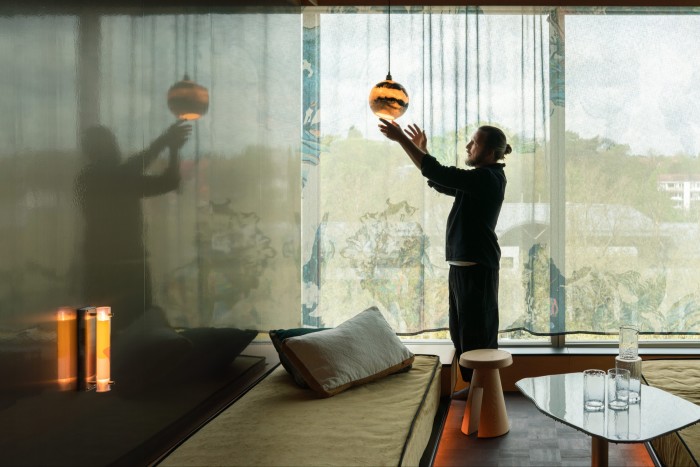 Jadot holds a Roxane Lahidji Hanging Salt Bulb in a bedroom at Mix