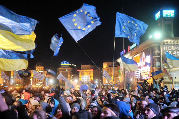 Protesters holding Ukrainian and EU flags