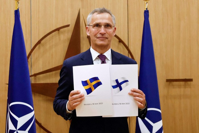 Nato Secretary-General Jens Stoltenberg poses with application documents presented by Finland and Sweden’s ambassadors to Nato 