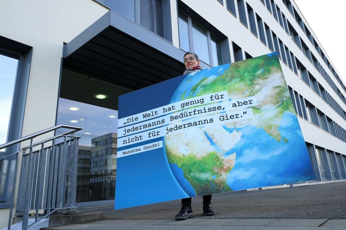 A woman protests in front of the CureVac HQ in Tubingen, Germany. Majority owner Dietmar Hopp refused to deny the company had been approached by the US and said: 'It goes without saying that a German company should not be developing a vaccine for exclusive use in the US'