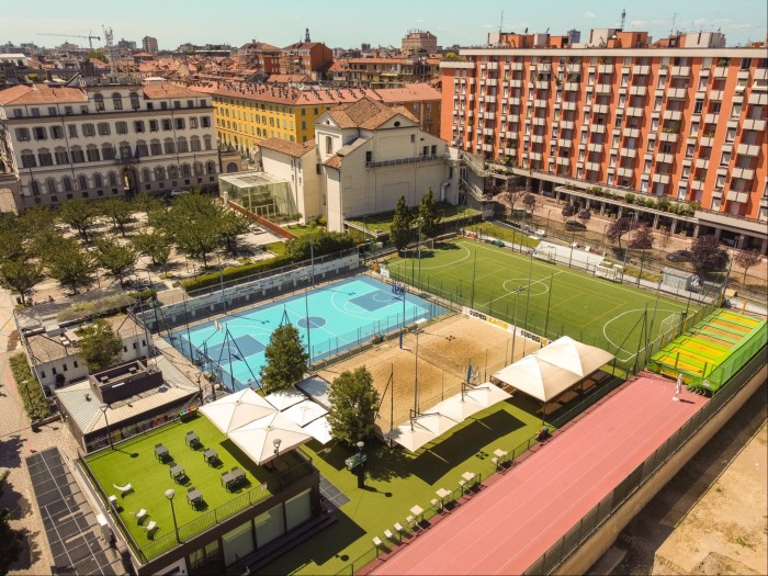 Aerial shot of a swimming pool and tennis courts in Milan’s PlayMore! complex 