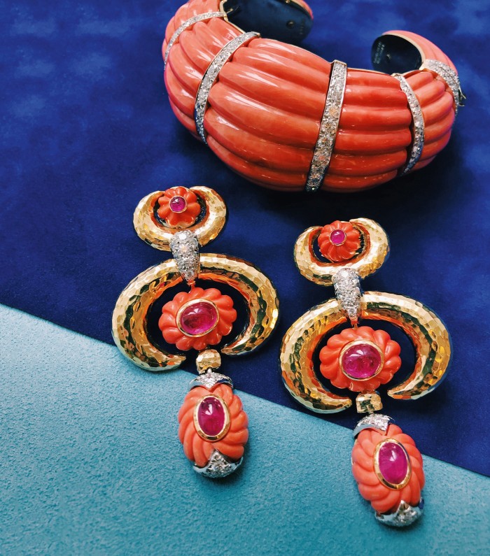 David Webb coral, diamond, gold and platinum fluted cuff, POA; and coral, diamond, cabochon ruby, gold and platinum crescent earrings, POA
