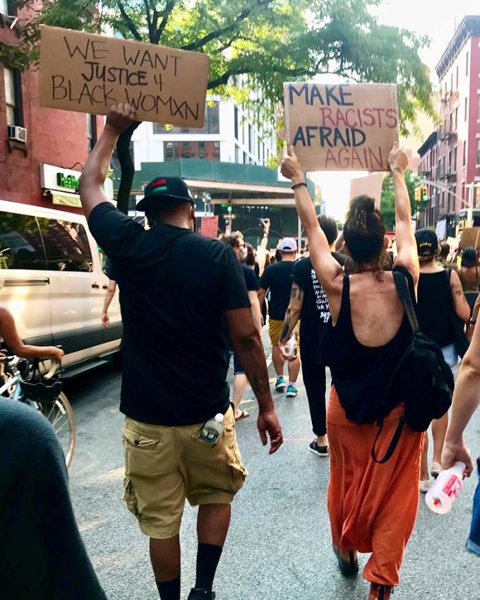 People holding up signs in support of people of colour at the West Side Highway protest, New York, August 2020