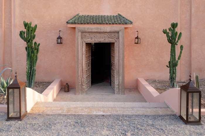 The sunken antique Indian door and cactus garden at the front entrance