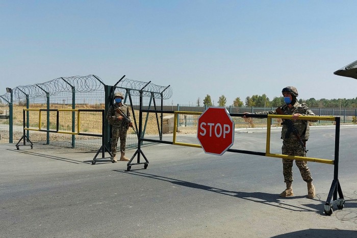 Uzbek soldiers guard a checkpoint which separates Uzbekistan and Afghanistan