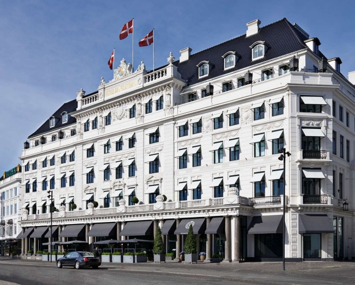 An external shot of Hotel d’Angleterre’s white facade against a blue sky 