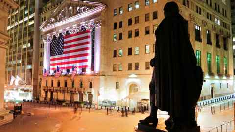 A night-time view of Wall Street and the New York Stock Exchange