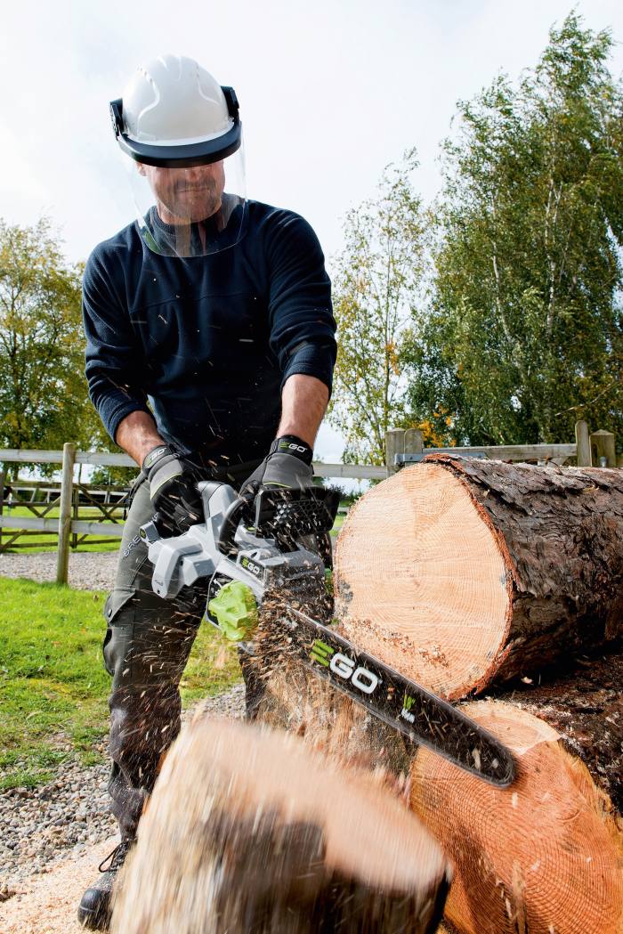 A woodsman cuts logs with the Ego Power Plus CS1610E chainsaw