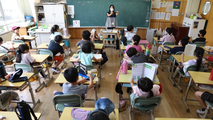 A teacher and her students inside a classroom in Japan