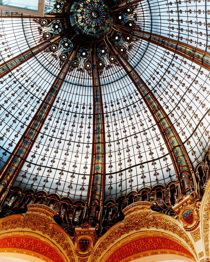 Huge glass dome with mostly white glass and stripes of coloured