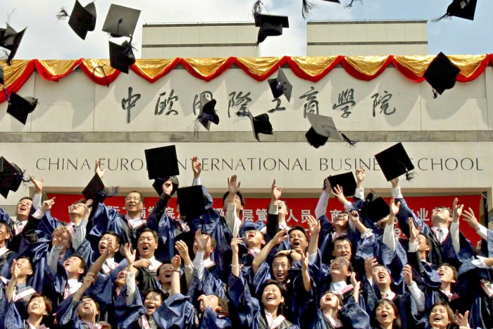 EMBA program graduates celebrate at the graduation ceremony in China Europe International Business School