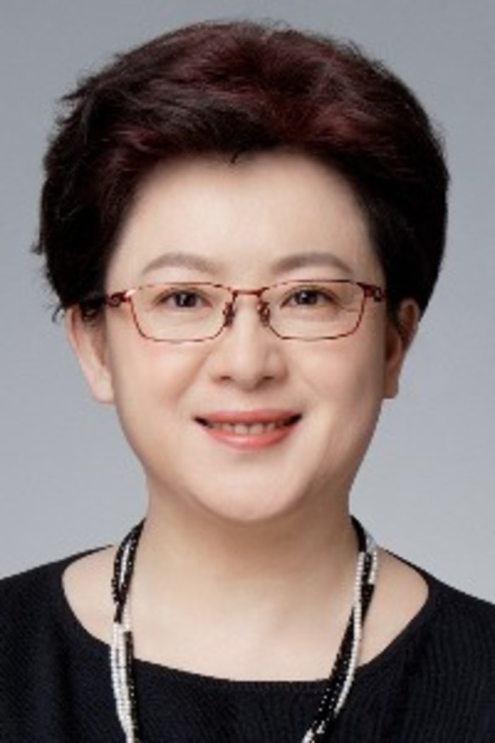 Susan Ning. A  Chinese woman wearing glasses in an office attire