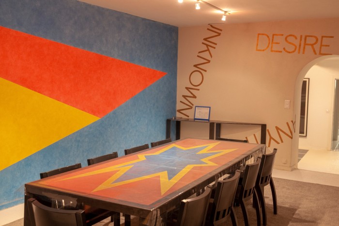 Asymmetrical Pyramid Drawing #428, 1985, and table, 1991, both by Sol LeWitt, and Untitled Wall Painting for Bernar, 2004, by Robert Barry in the mill’s dining room