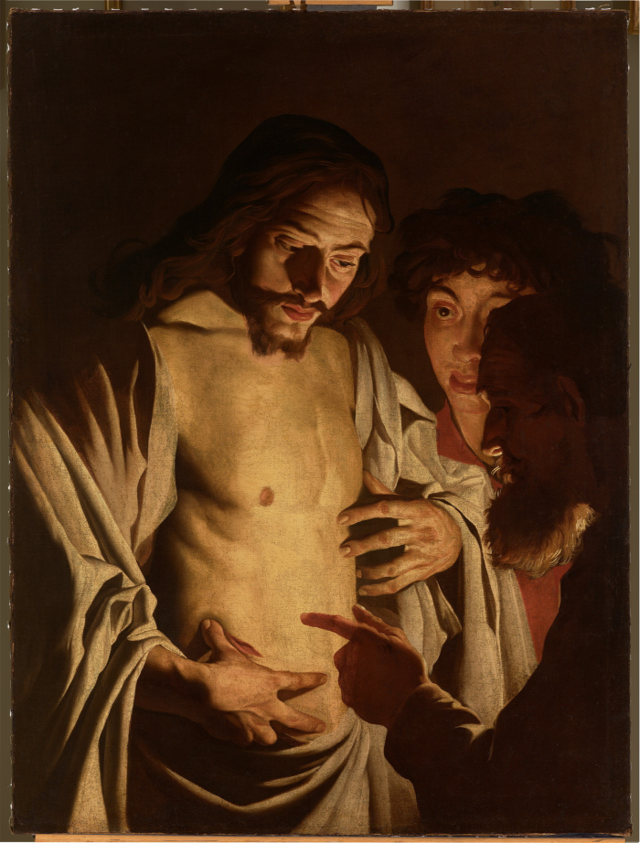 Painting of a man in shadow pointing at the chest wound of a man illuminated by candlelight