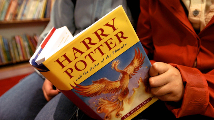 A child reads Harry Potter and the Order of the Phoenix