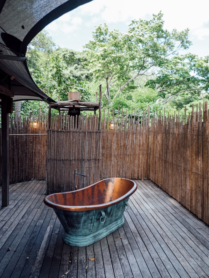 The rooms have open-air showers and copper tubs