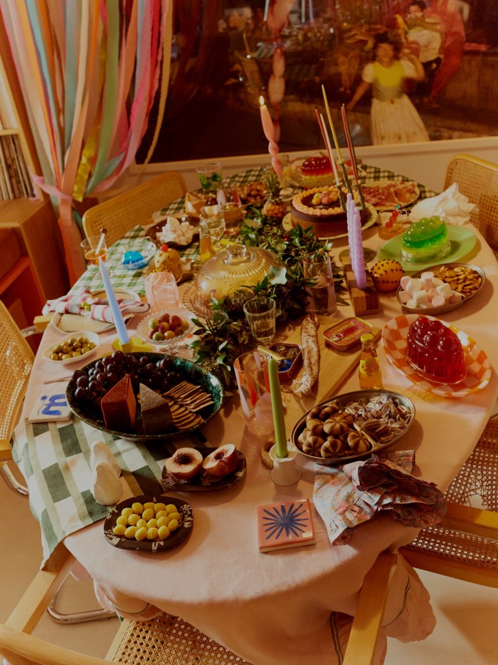A table laid with desserts by Laura Jackson