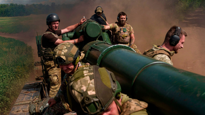 Ukrainian soldiers atop a self-propelled howitzer 