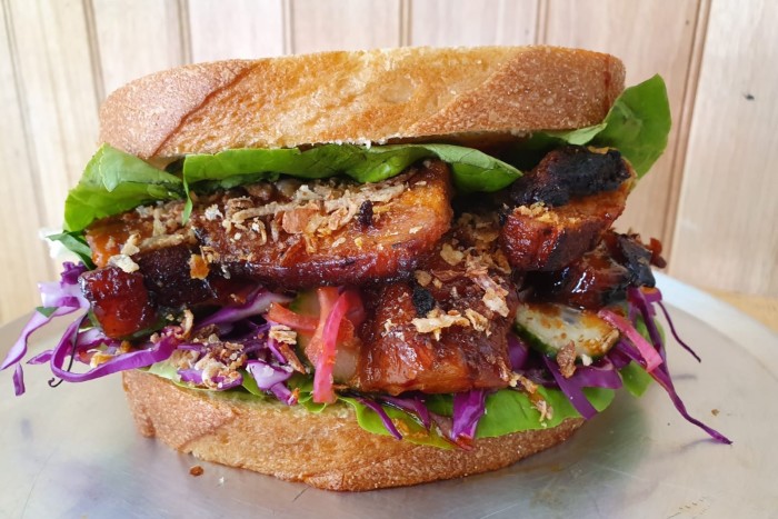 The Pork Sambo at Mrs Palmer, Sydney, with pork belly, burnt butter ricotta, garlic sauce, lettuce, purple cabbage, cucumber, soy and crispy shallots